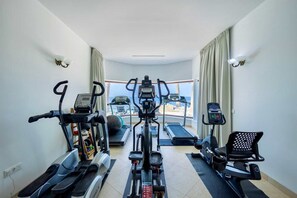 A home gym with treadmills, elliptical machines, and a stationary bike. - Elegant seaside retreat with private beach (Sint Willibrordus)