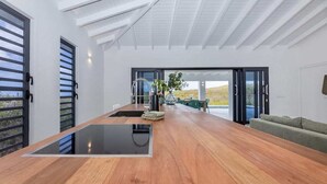 A modern kitchen with a central island, large windows, and a view of the outdoors. - Modern villa with infinity pool and sea views - Coral Estate (Sint Willibrordus)