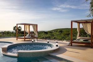 A hot tub with two wooden canopy beds, a pool, and a view of the ocean. - Serene luxury retreat with pool and sea views (Sint Willibrordus)