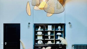A room with a wooden dining table, a black cabinet with shelves, and a ceiling light fixture. - Provencal Escape: Villa with Pool and Pool House in the Heart of the Luberon (La Tour-d'Aigues)