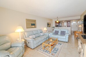 A living room with a sofa, armchairs, a coffee table, and a dining area with a table and chairs. - St. Augustine Beach & Tennis Club 419 (St. Augustine)