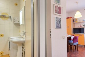 A bathroom with a sink, toilet, and shower.