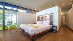A modern bedroom with a large bed, built-in wardrobe, and a view of the outdoors. - Ocean Views Open Plan Pool 3 Bed (Cape Town)