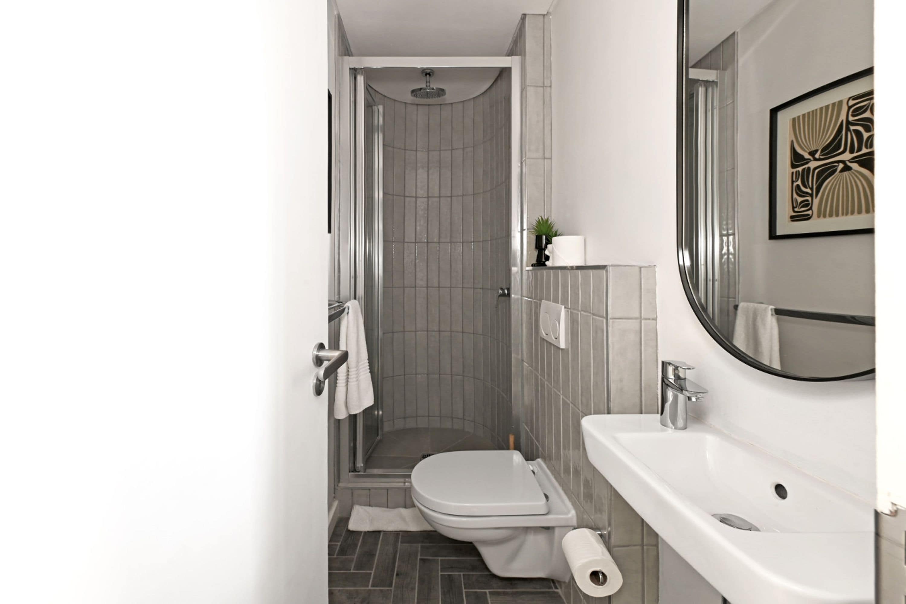 Un baño moderno con ducha, inodoro y lavabo.
