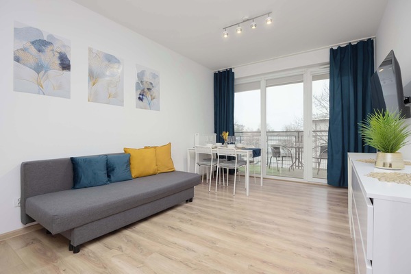 Relax in the stylish living room with a comfortable sofa and modern decor.