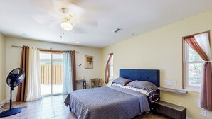 A bedroom with a bed, a ceiling fan, a window with curtains, and a small table. - 3 Mi to Ocala Square! Family Getaway w/ Pool (Ocala)