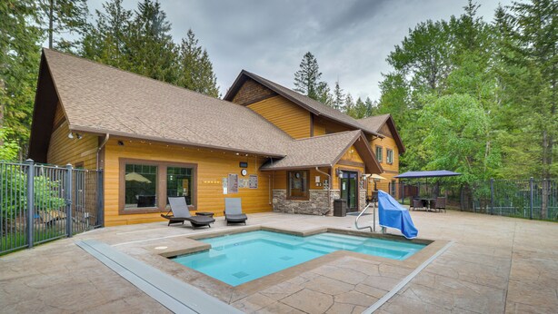 A wooden cabin with a swimming pool, outdoor seating, and a covered patio. - Secluded Mtn Retreat w/ Resort Perks in Whitefish! (Whitefish)