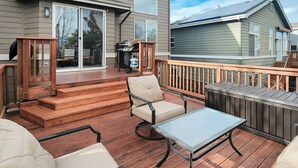 A deck with outdoor furniture, a barbecue grill, and a sliding glass door leading to a patio. - Littleton Home w/ Deck - 24 Mi to Denver! (Littleton)