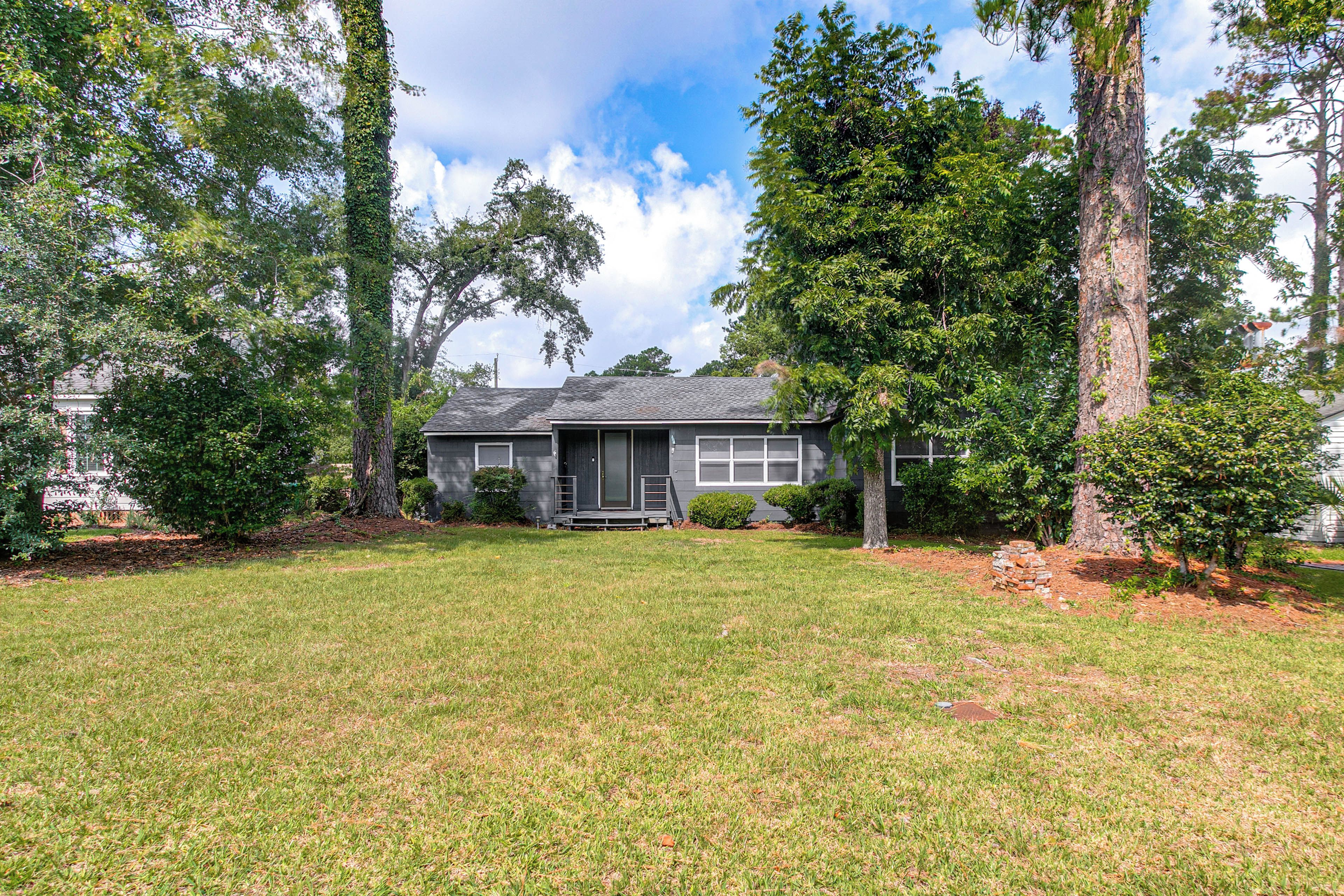 A residential house with a front yard, a driveway, and a mailbox.