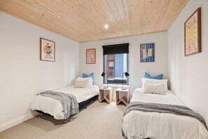 A bedroom with two beds, a window, and artwork on the walls. - Cora Lynn 14 (Lorne)