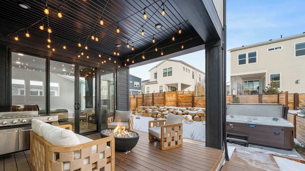 An outdoor patio with wooden furniture, a fire pit, and a hot tub. - Ski Chalet Chic Retreat With Hot Tub (Park City)