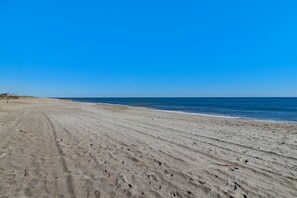 A wide sandy beach with footprints leading to the water. - Private Pool and Hot Tub Fernandina Beach Retreat (Fernandina Beach)