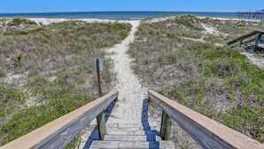 A wooden boardwalk leading to a beach with sand dunes and sparse vegetation. - Freshly Renovated 2BR Dream Condo Beachfront Stunning Views (Fernandina Beach)