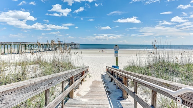 A wooden boardwalk leading to a beach with a clear sky and clouds. - Ground Floor Beachfront Condo Amelia by the Sea (Fernandina Beach)