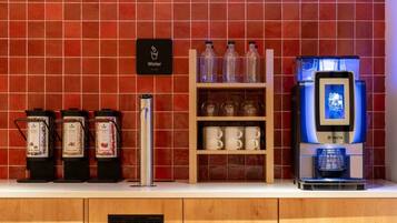 A coffee station with a water dispenser, a coffee machine, and various coffee containers.