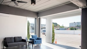 A modern interior with a grey sofa, a blue armchair, and a small table.