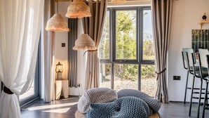 A cozy room with a large window, woven hanging lamps, and a bean bag chair. - 2 Bed in Pensilva (oc-s30446) (Pensilva)