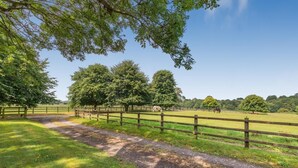 A rural landscape with a dirt path, wooden fences, and trees. - 1 Bed in Ashton (oc-p30484) (Ashton)