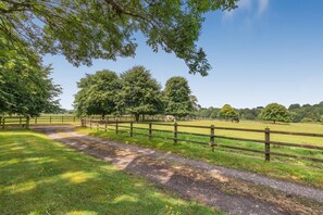 A rural landscape with a dirt path, wooden fences, and trees. - 1 Bed in Ashton (oc-p30484) (Ashton)