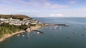 A coastal town with a marina, houses along the shore, and a clear view of the sea. - 2 Bed in Llwyndafydd (oc-c31062) (Llandysiliogogo)