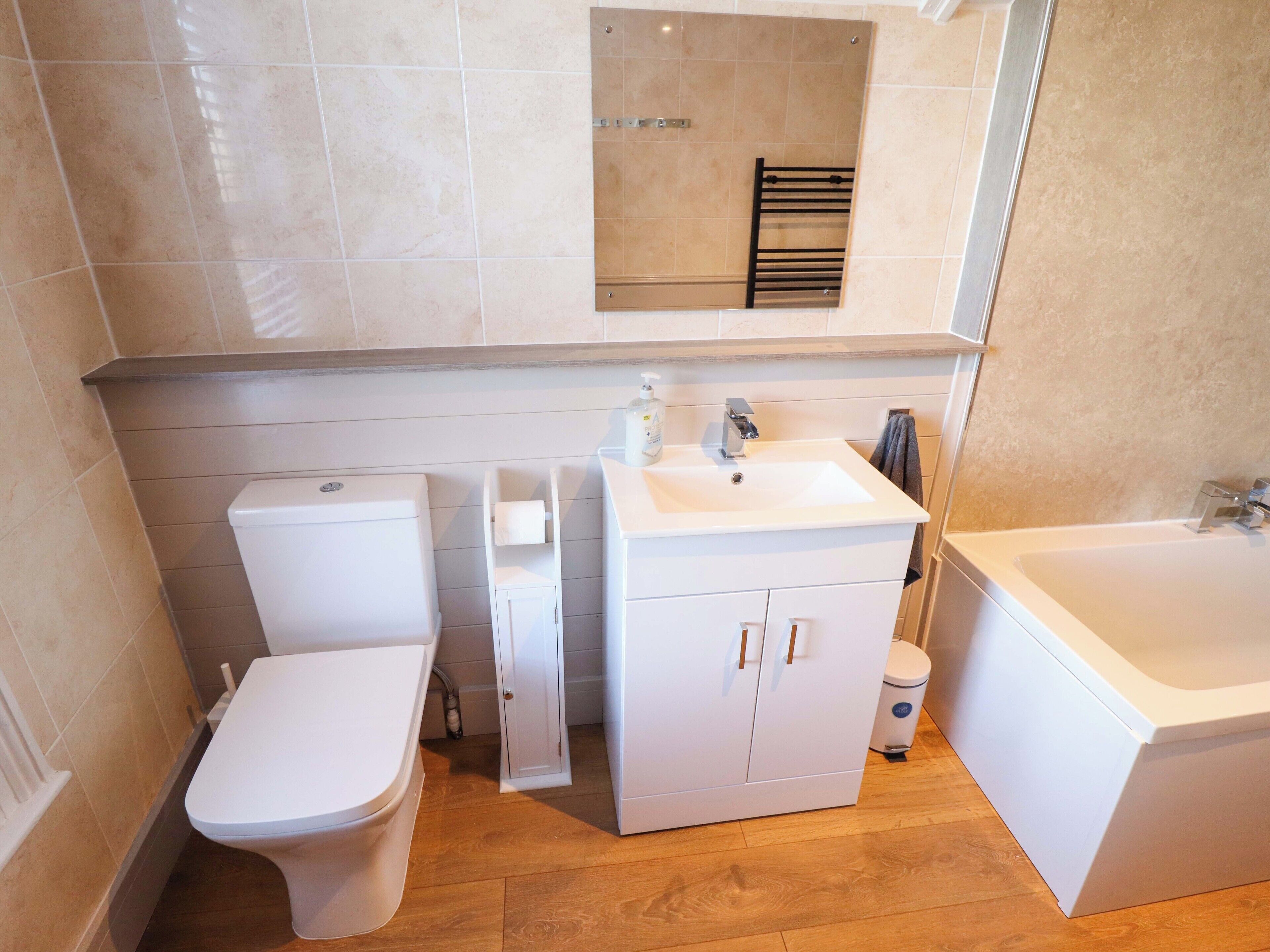 A compact bathroom with a toilet, a sink, and a bathtub.