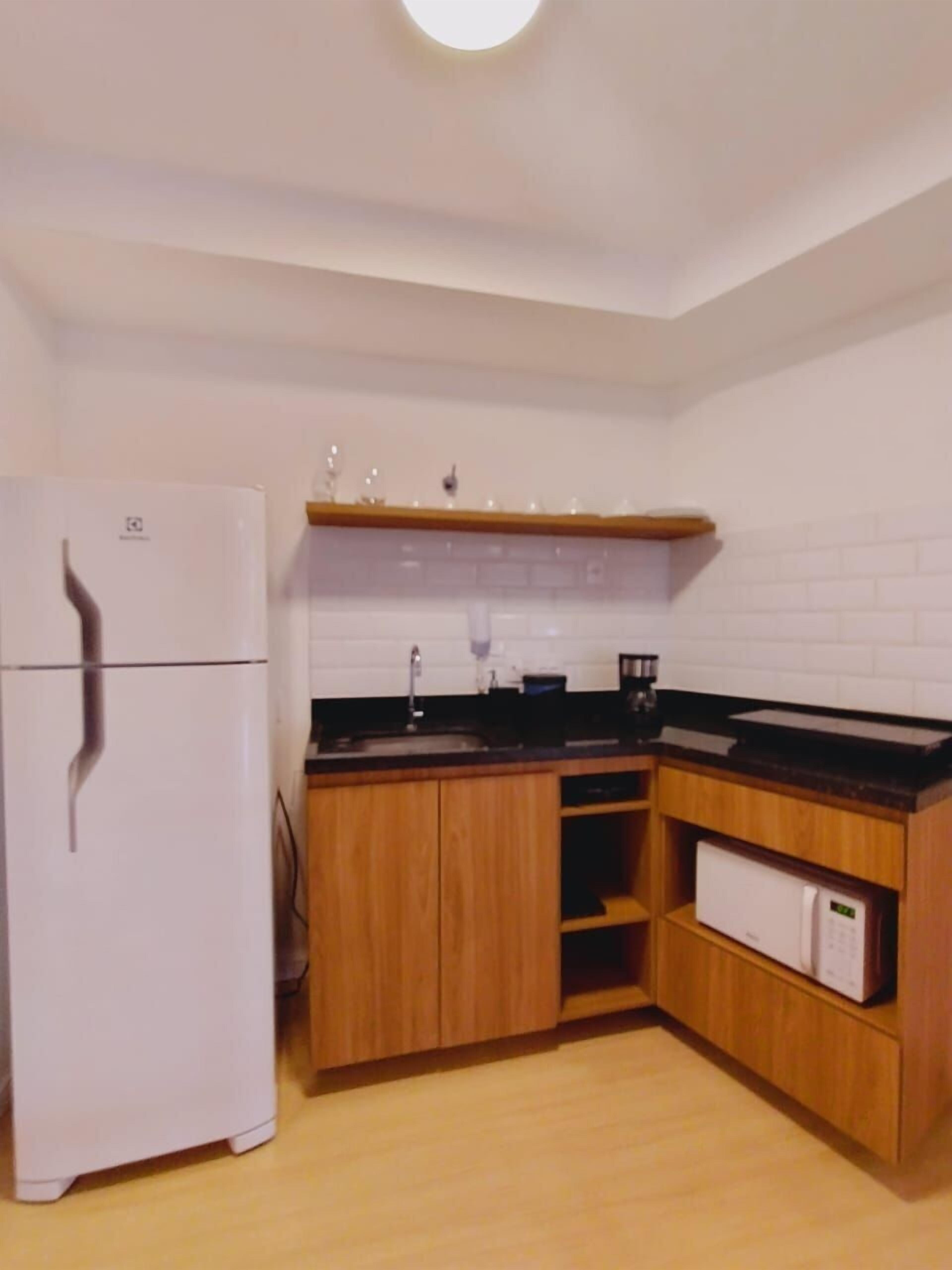 Fridge, microwave, coffee/tea maker, cookware/dishes/utensils