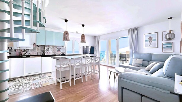 A modern living room with a sofa and a dining area with chairs and a table. - Albaida Gardens (El Morche)