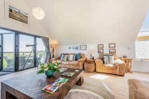 A spacious living room with a large window, a wooden coffee table, and a sofa set. - 4 Bed in Northam (oc-n32452) (Northam)