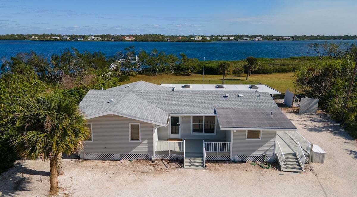 A single-story house with a covered patio, a front porch, and a small deck.