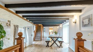 A wooden staircase with a modern kitchen in the background. - 3 Bed in Fairy Cross (oc-g32972) (Ford)