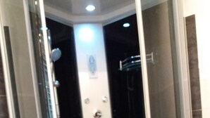 A glass-enclosed shower stall with a handheld showerhead, a handheld faucet, and a wall-mounted control panel. - B & B CELESTE BEDONIA 5 minutes from town center (Bedonia)
