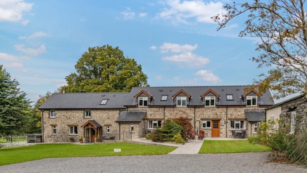 A two-story stone building with a symmetrical facade, a central entrance, and a gravel driveway. - 2 Bed in Ponthirwaun (oc-c33293) (Ponthirwaun)