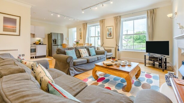 A modern living room with a sofa set, a coffee table, and a TV. - 3 Bed in Fowey (oc-o33078) (Fowey)