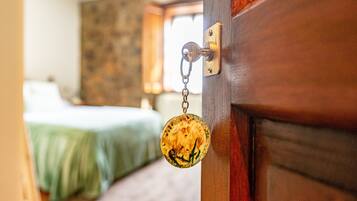 A wooden door with a brass handle and a keychain.