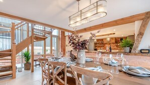 A dining area with a wooden table, chairs, and a chandelier. - 4 Bed in Moccas (oc-r33126) (Moccas)