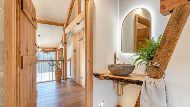 A wooden interior with a stone sink, a mirror, and a plant. - 4 Bed in Moccas (oc-r33126) (Moccas)