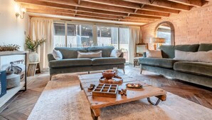 A cozy living room with a wooden ceiling, a sofa set, a coffee table, and a brick wall. - 4 Bed in Moccas (oc-r33126) (Moccas)