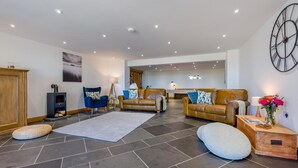 A spacious living room with a fireplace, two sofas, a coffee table, and a rug.