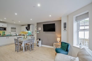 A modern apartment with a kitchen, dining area, and living room. - 2 Bed in Benllech (oc-t34071) (Benllech)