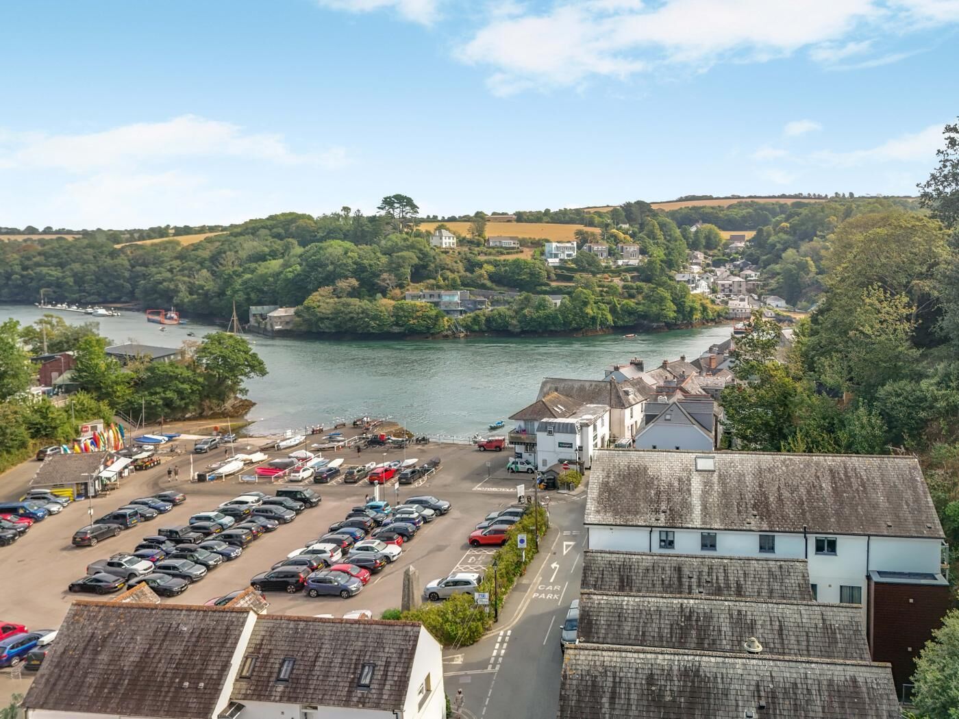 A coastal town with a parking lot and a river.