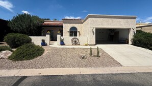 A single-story house with a garage, surrounded by landscaping and a clear sky. - Luxury Vacation Rental in historic Tubac, Arizona --Come see Southern Arizona! (Tubac)
