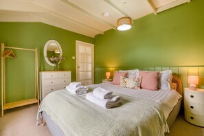 A bedroom with a bed, bedside tables, a dresser, a mirror, and a hanging wardrobe. - 3 Bed in St. Merryn (oc-l34453) (Porthcothan Bay)