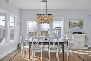 Dining - Stunning top-floor penthouse retreat in the heart of Atlantic Beach! This spacious 4-bedroom, 3-bath condo features a great room with a fireplace, a bonus loft space with a poker table, and elevator access from the carport for effortless arrivals. (Atlantic Beach)