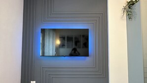 A modern wall with a recessed TV and a decorative panel. - [Venice-Mestre]Design Apartment Bros#1 (Venezia)