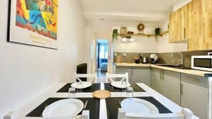 A modern kitchen with a dining area.