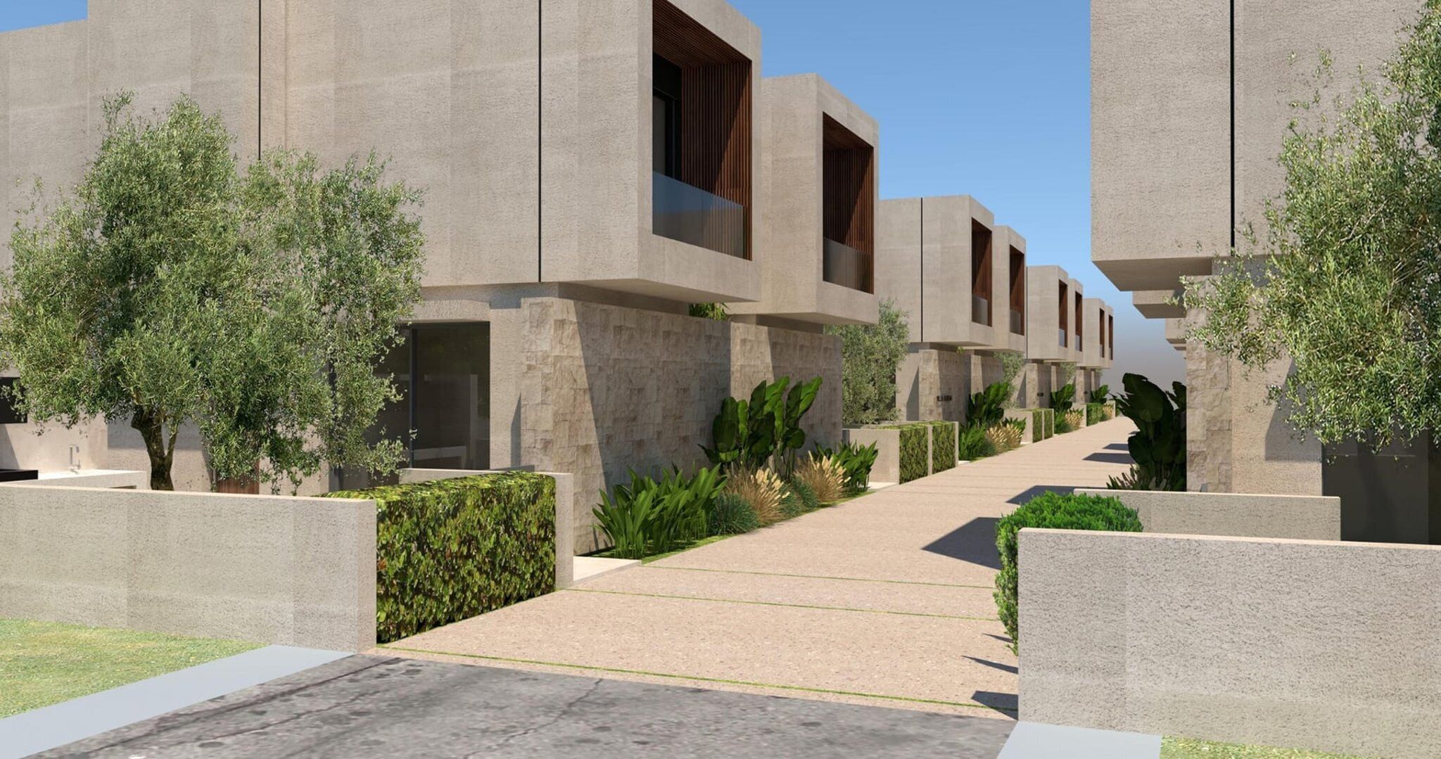 Un moderno complejo arquitectónico con edificios de concreto, un sendero central y vegetación.
