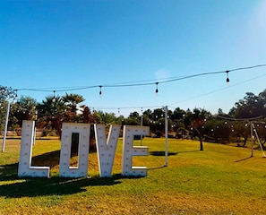 Outdoor letters spelling 'LOVE' on a grassy field with string lights overhead. - Room 'Mirto' with Mountain View, Wi-Fi and Air Conditioning (Uta)