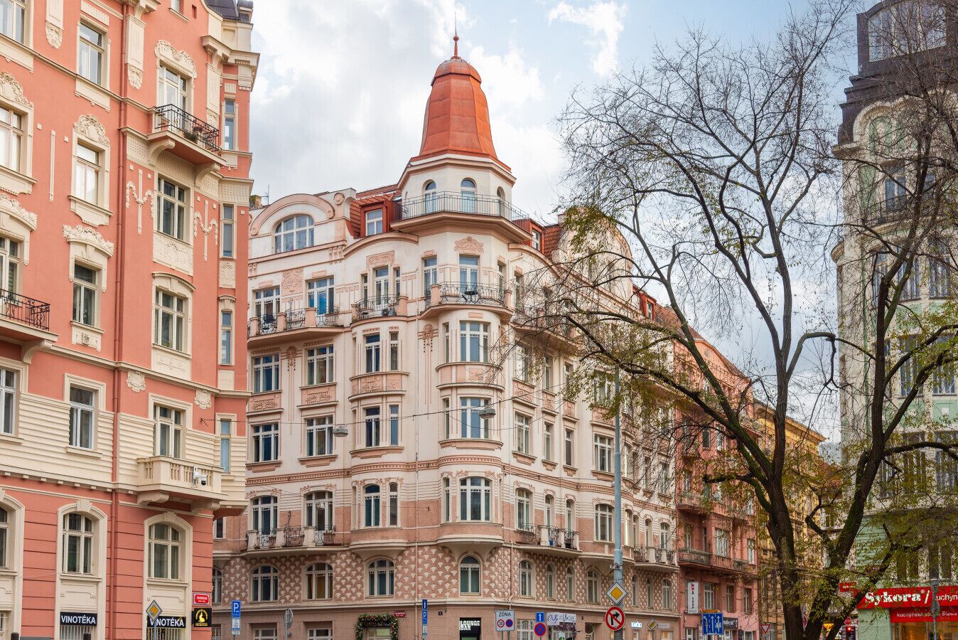 A multi-story building with ornate architectural details, including balconies and decorative moldings.