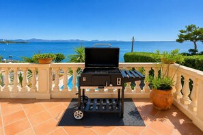 A portable grill on a balcony with a view of the sea and mountains. - Villa Casa Faro - Four Bedroom Villa, Sleeps 8 (Mallorca)