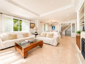 A spacious living room with a sofa set, a coffee table, and a fireplace. - Villa Casa Faro - Four Bedroom Villa, Sleeps 8 (Mallorca)